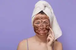 Natural handmade scrub in woman's face