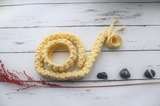 knitted yellow necklace in making process