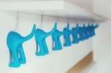 DIY jewelry hanger with blue plastic toys in white wooden plank