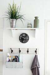 White wall hanger for multiple stuff with back clock in the middle