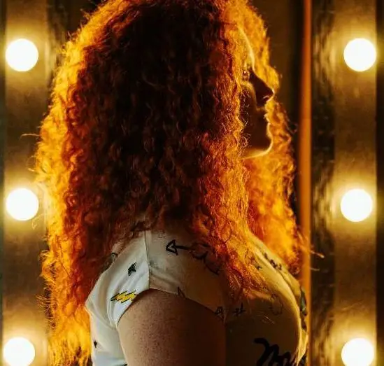 Girl standing near a vanity mirror